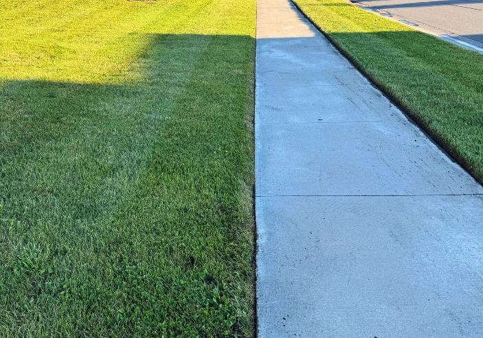 Crisp lawn edging for driveways and garden beds in Rogers Minnesota