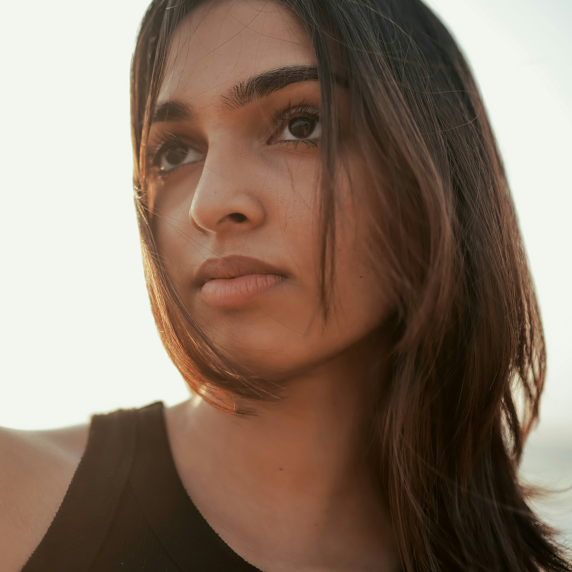 Woman with a defined jawline in soft beach light