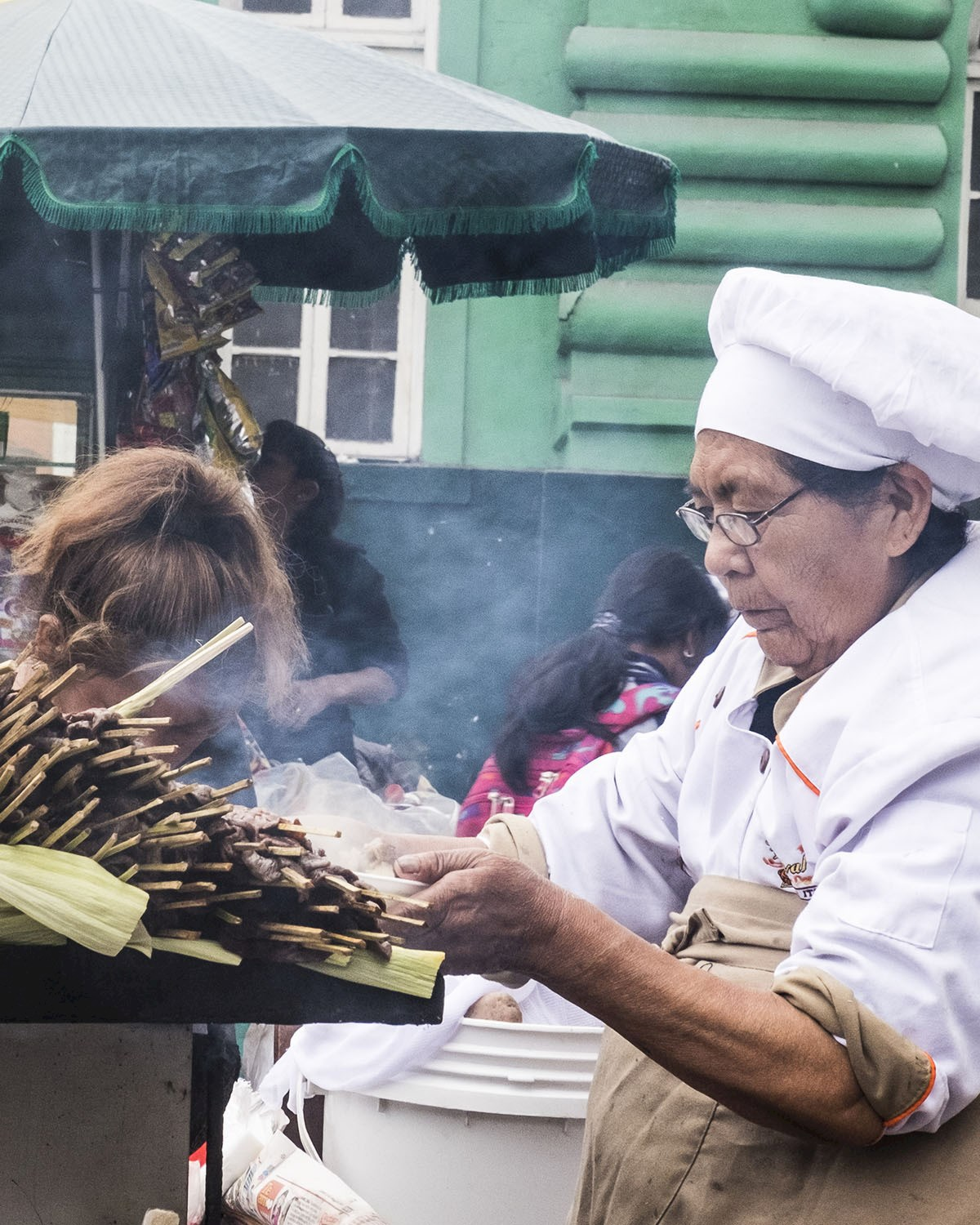 Traditional Peruvian cook preparing food at a local market
