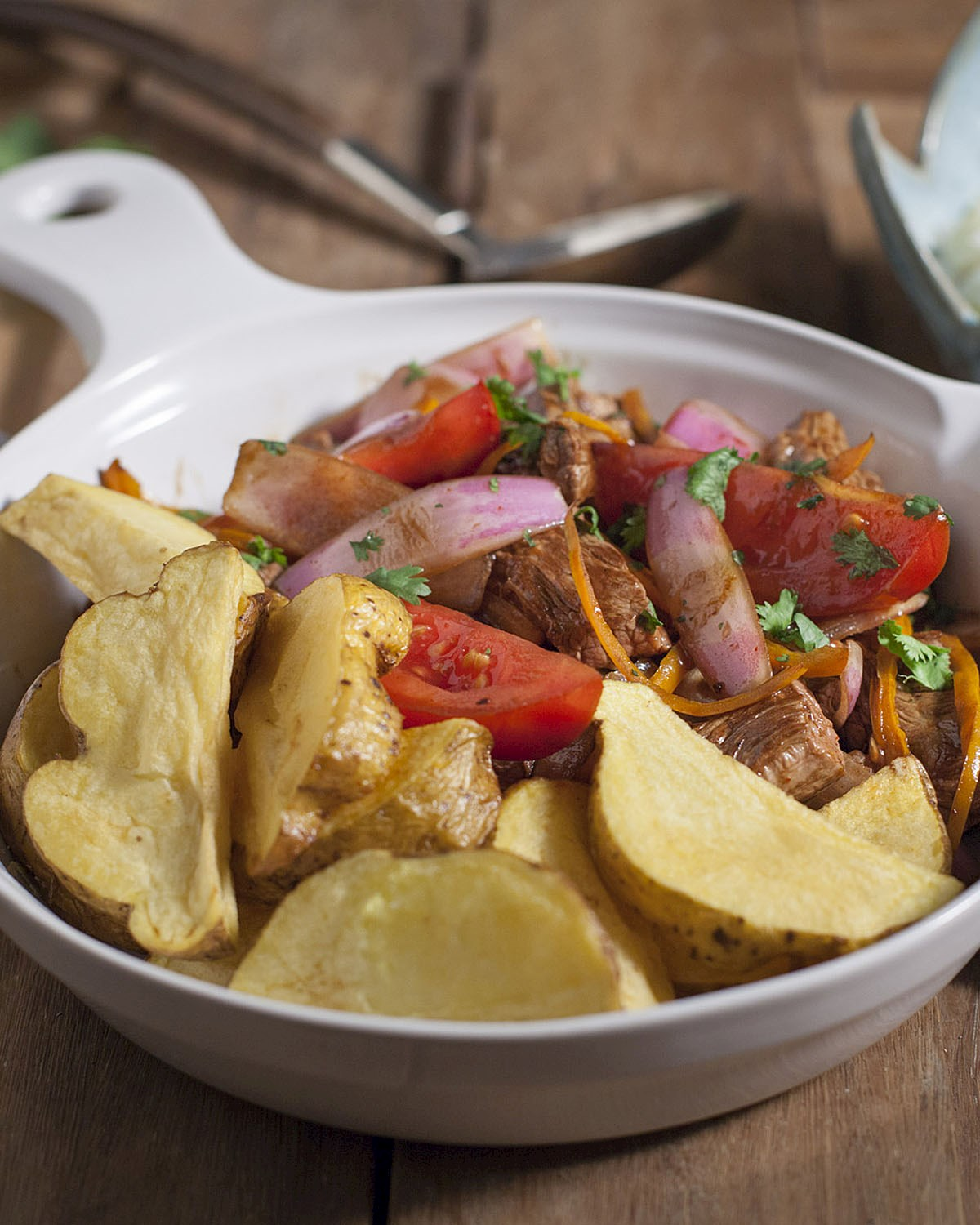 Peruvian lomo saltado with beef, tomatoes, onions, and golden potatoes