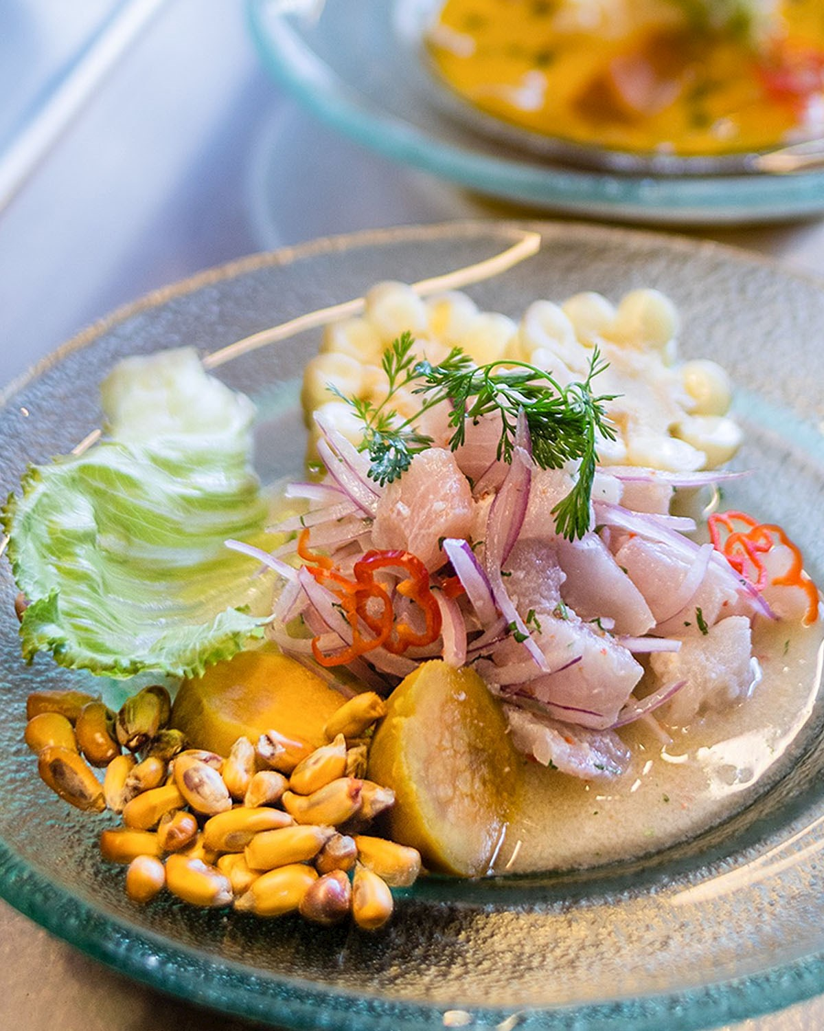 Traditional Peruvian ceviche served with corn, sweet potato, red onion, and chili