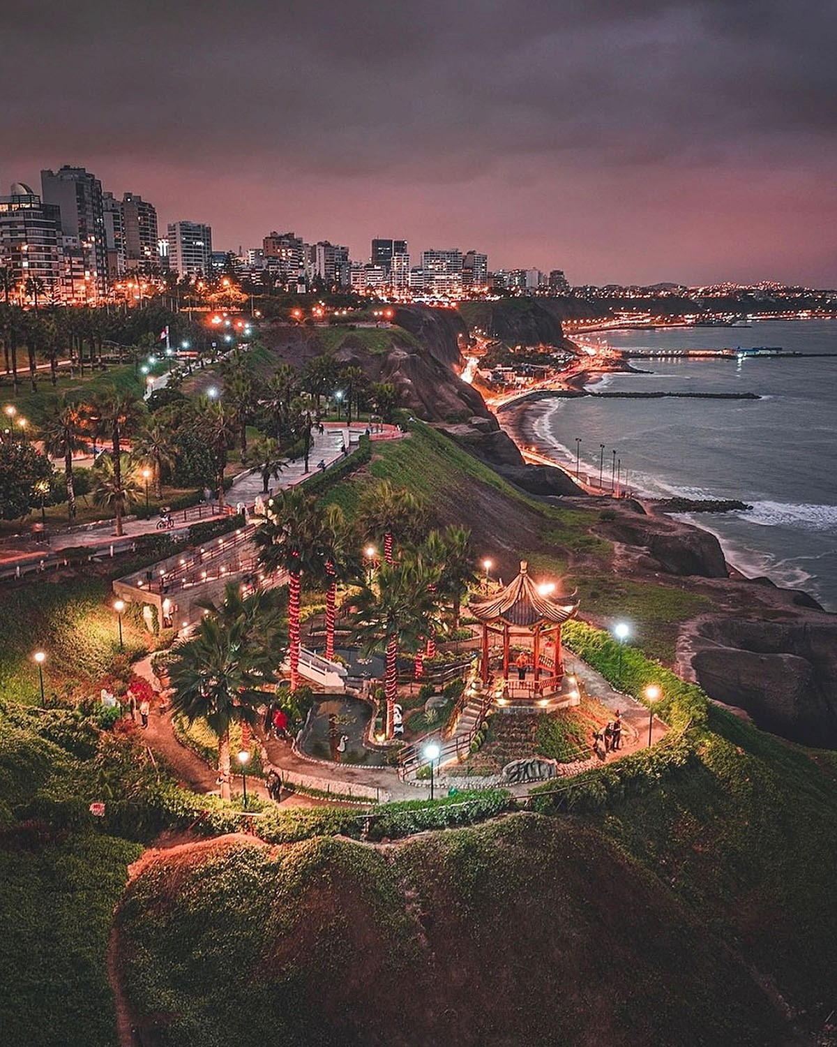 Lima’s illuminated coastline and Costa Verde at sunset