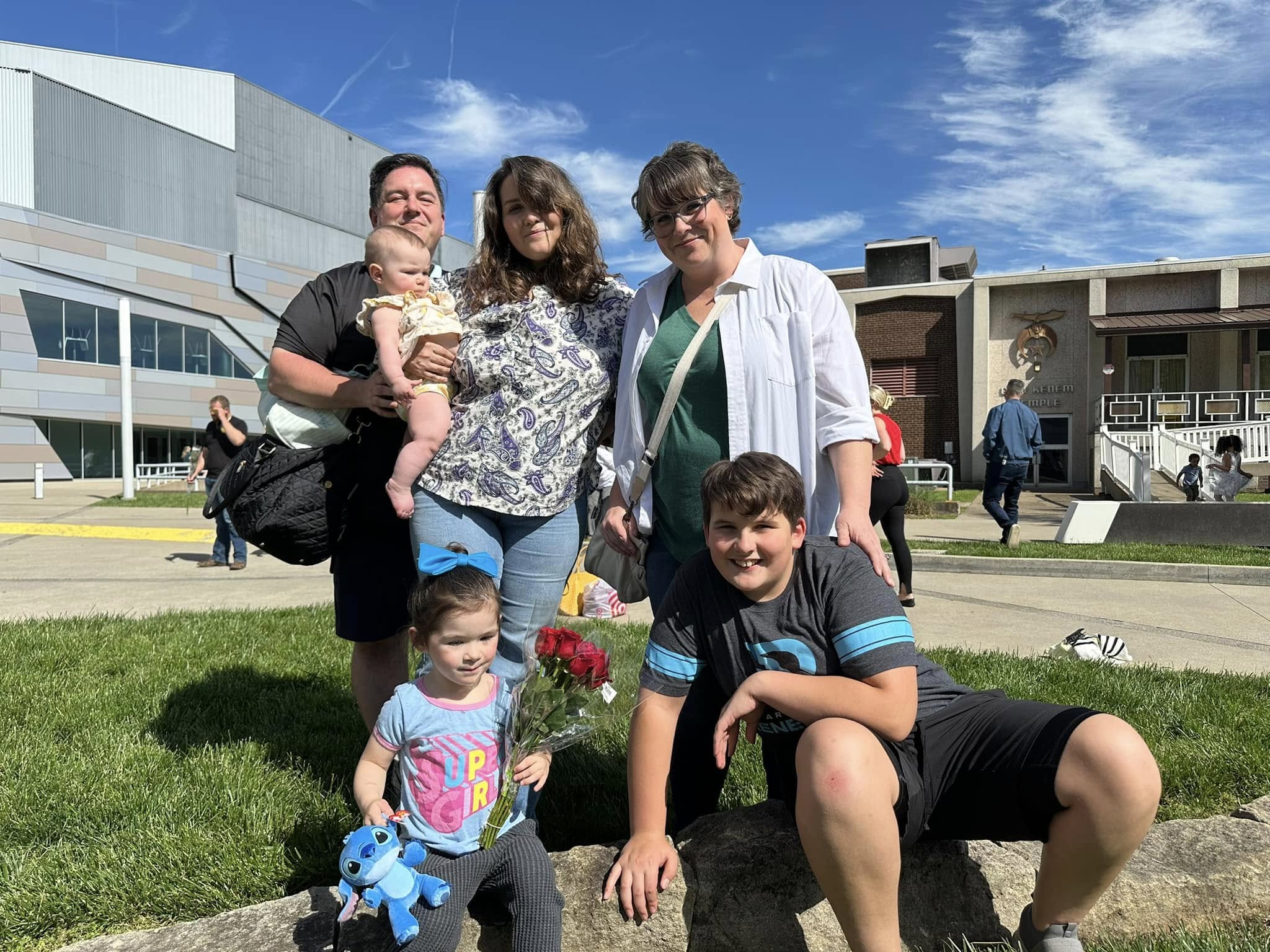 Sean Hyde with his family outdoors on a college campus