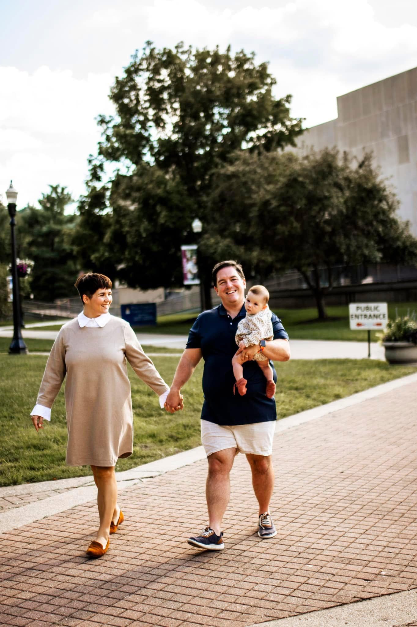 Sean Hyde walking with his family and baby on a college campus