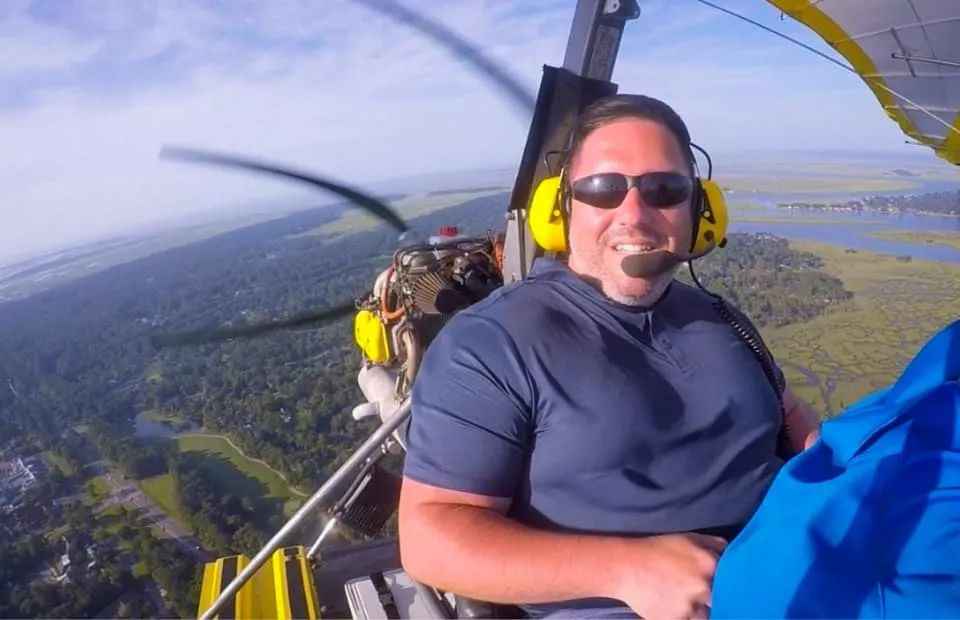 Sean Hyde wearing a headset on an ultralight flight