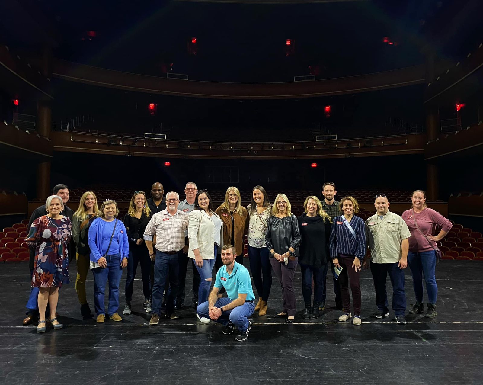 Sean Hyde with a large group of workshop participants on a theater stage