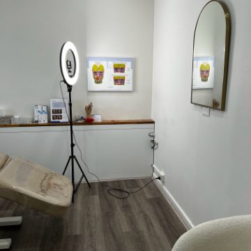 Consultation area with ring light and facial skin diagrams at Kozie Skin Clinic