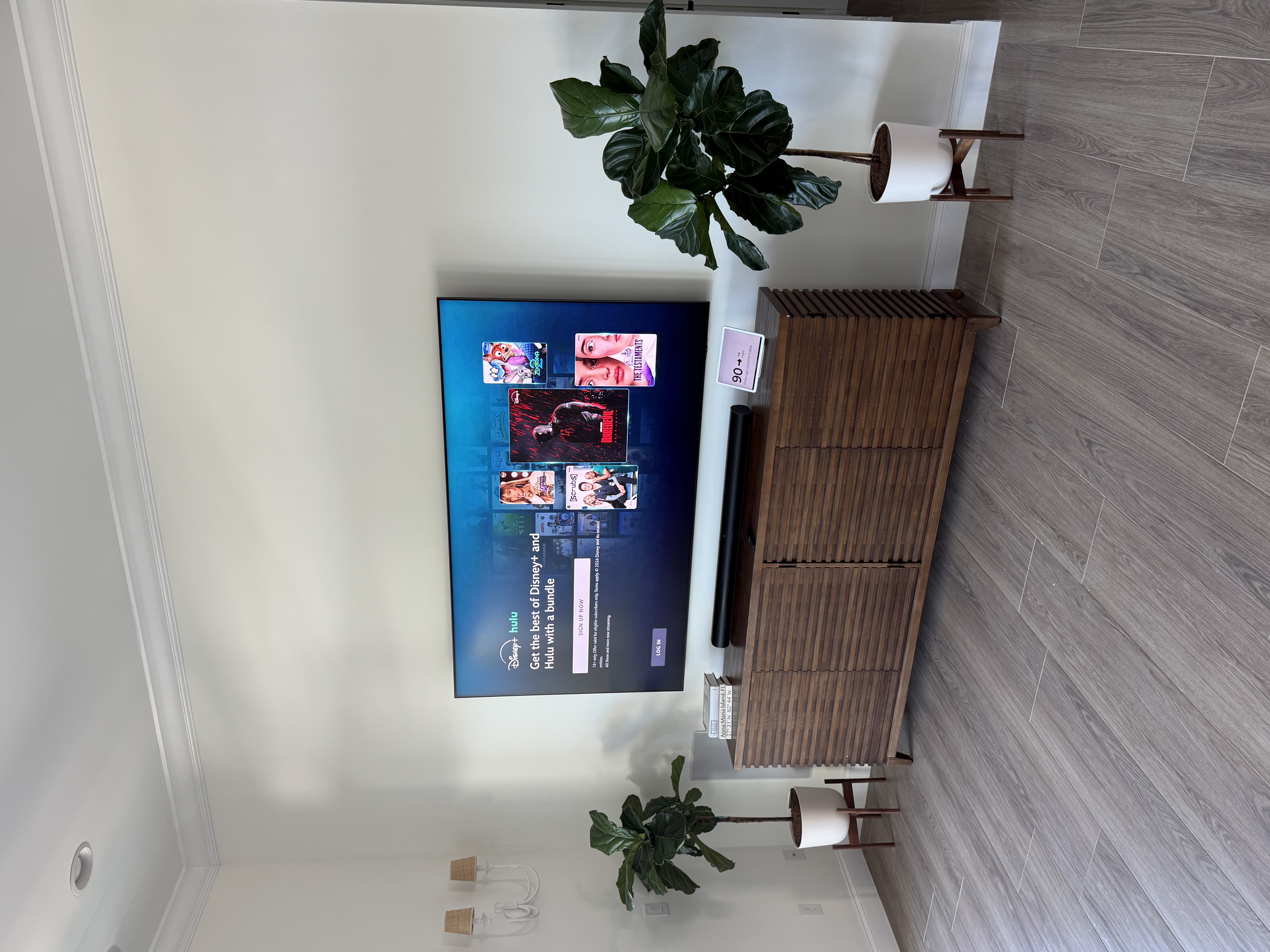 Professional TV mounting with a tilt bracket and a power connection installed behind the TV