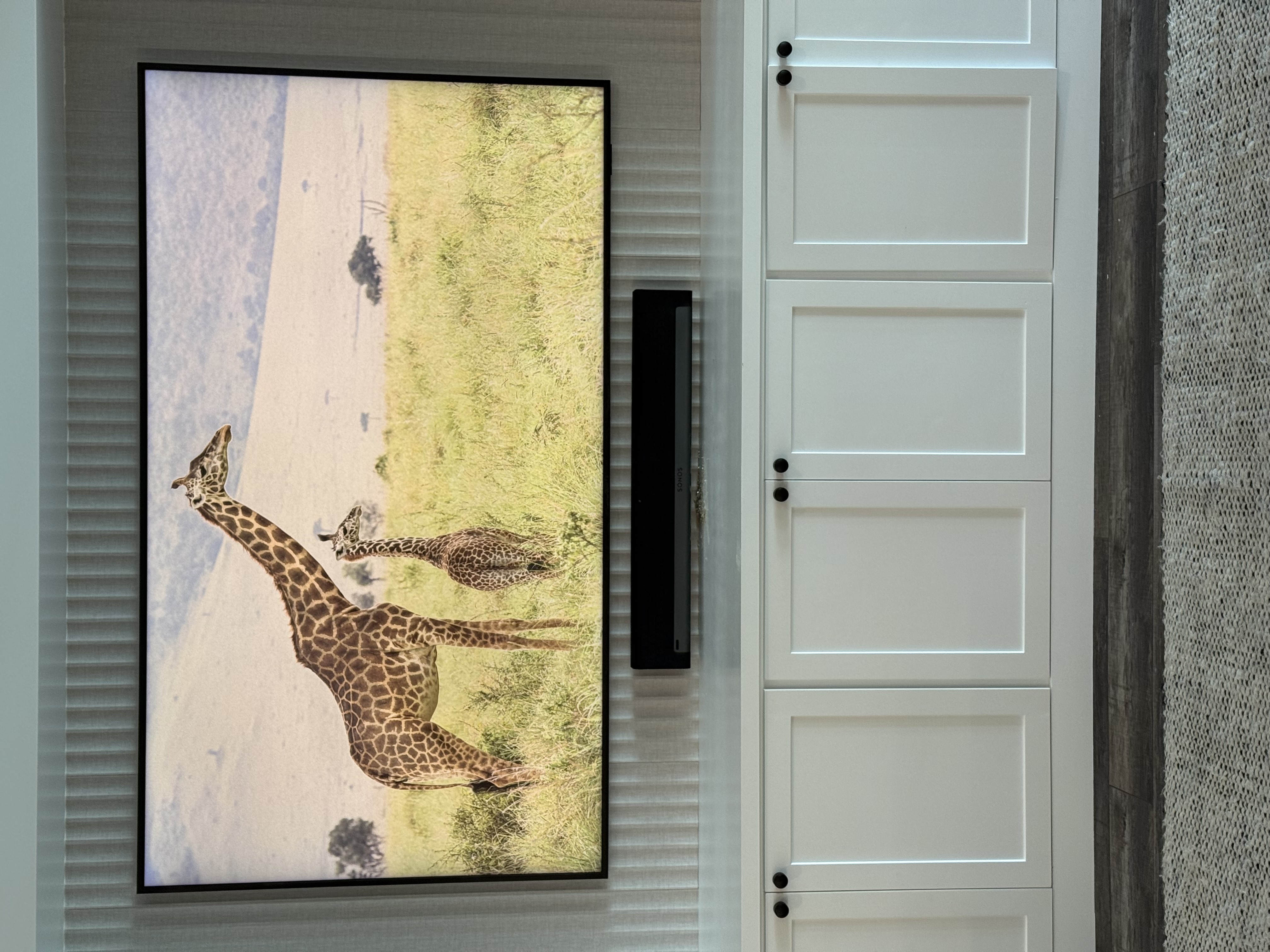 Soundbar professionally mounted below a wall-mounted TV with precise alignment