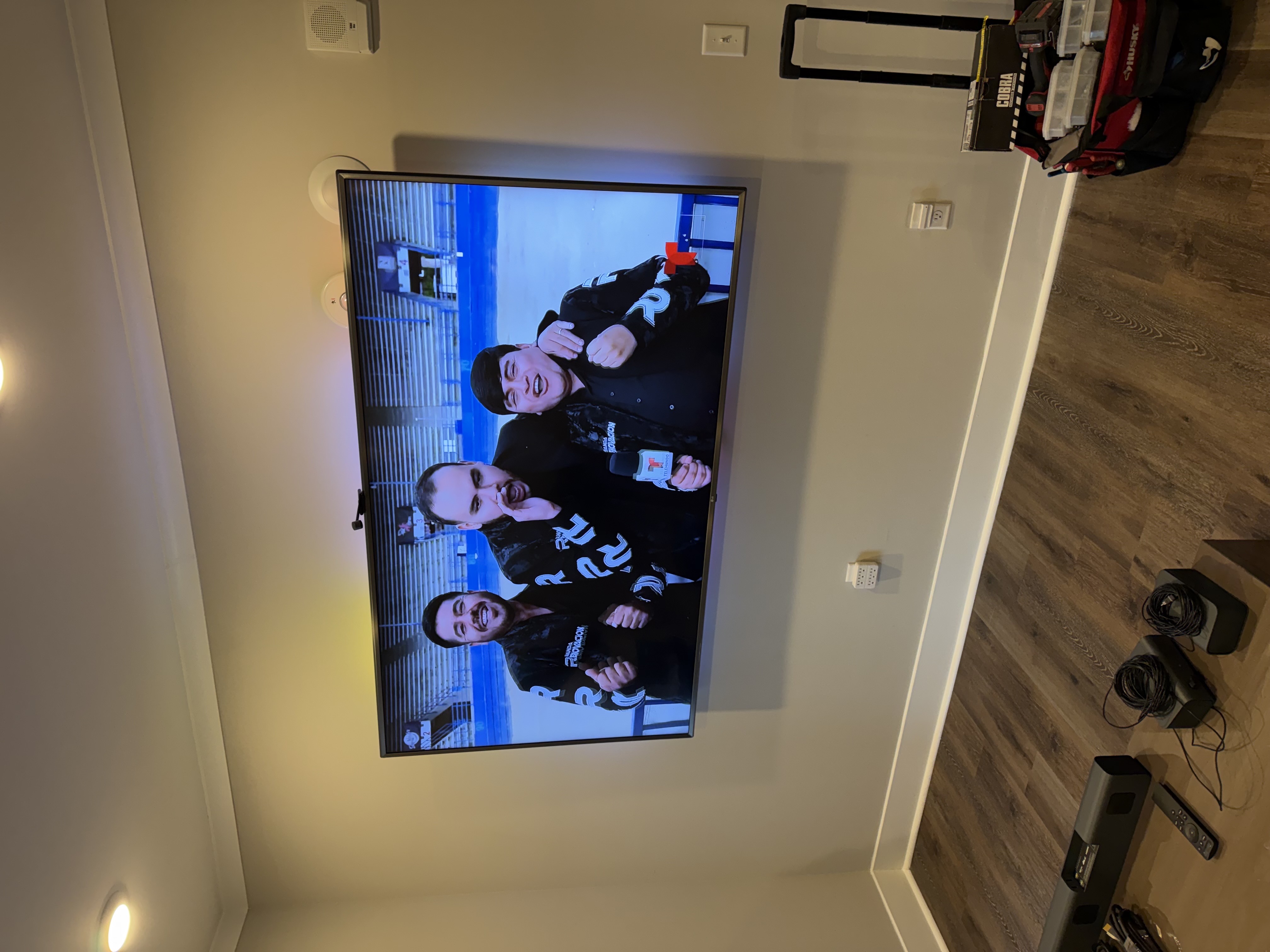 Professional TV mounting with a tilt wall-mount bracket installed for a secure mount
