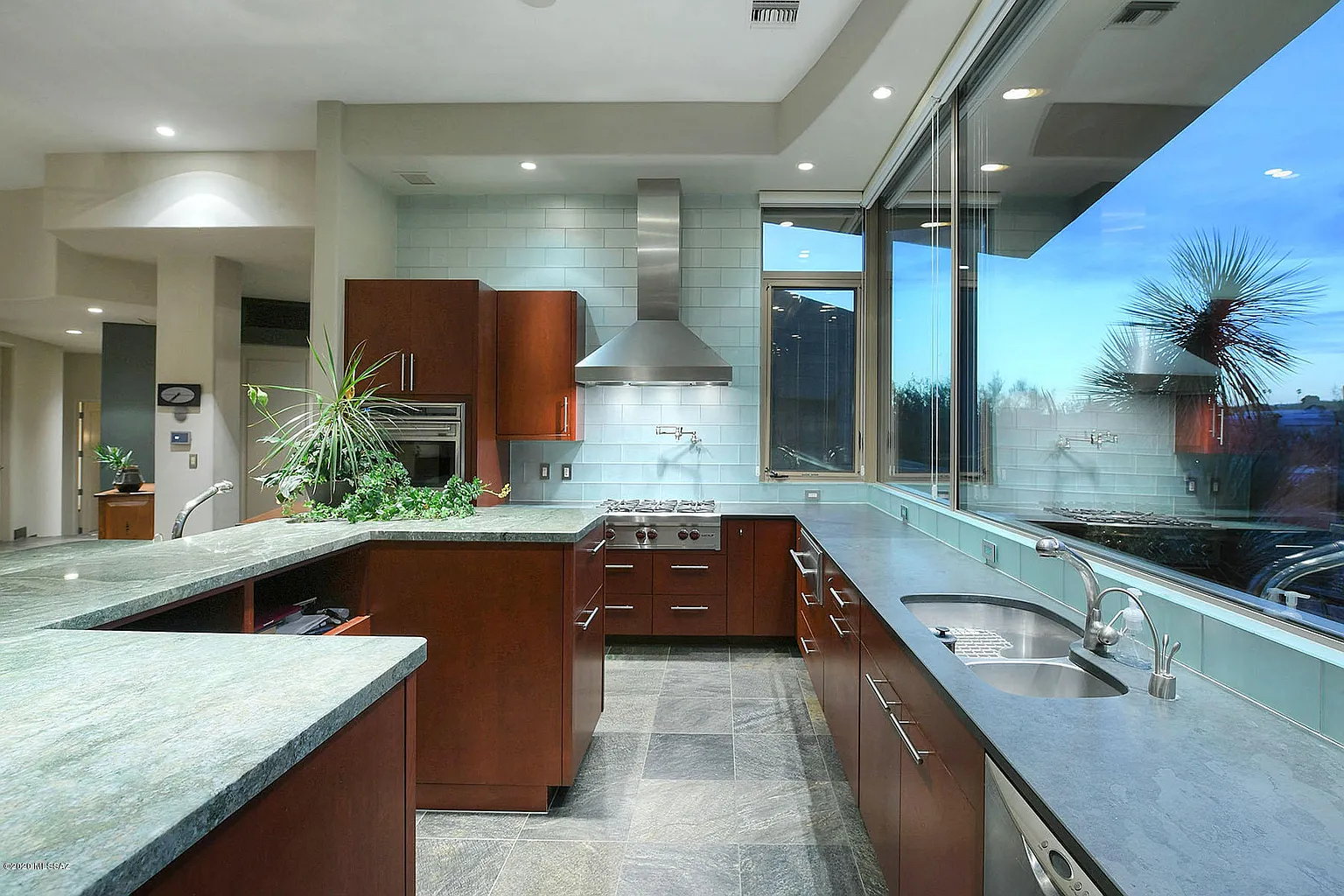 Contemporary cherry kitchen with flat-panel cabinets and a grain-matched island from the Pima Canyon project by Myk's Woodworking in Tucson