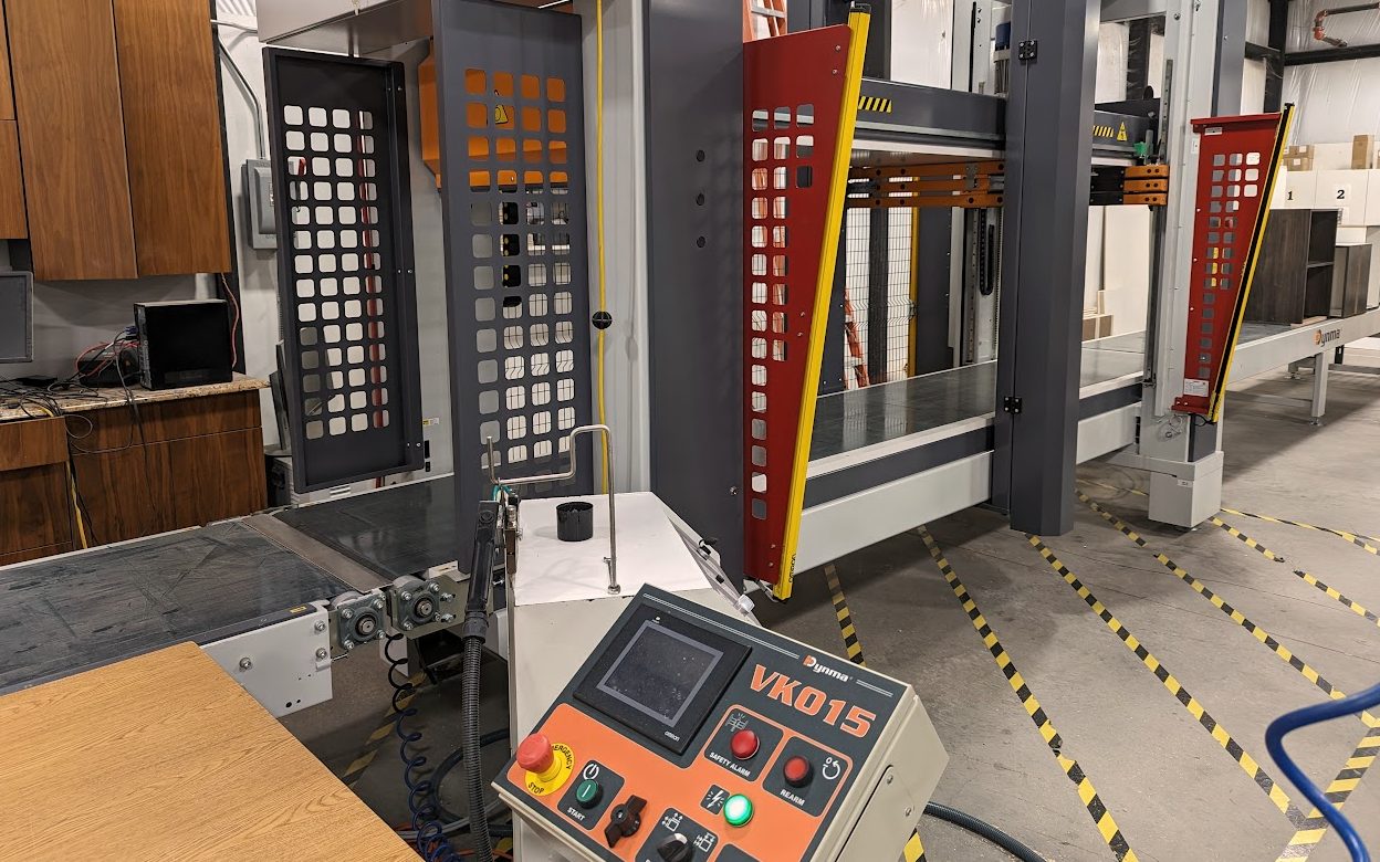 Automated panel press on the custom cabinet production floor
