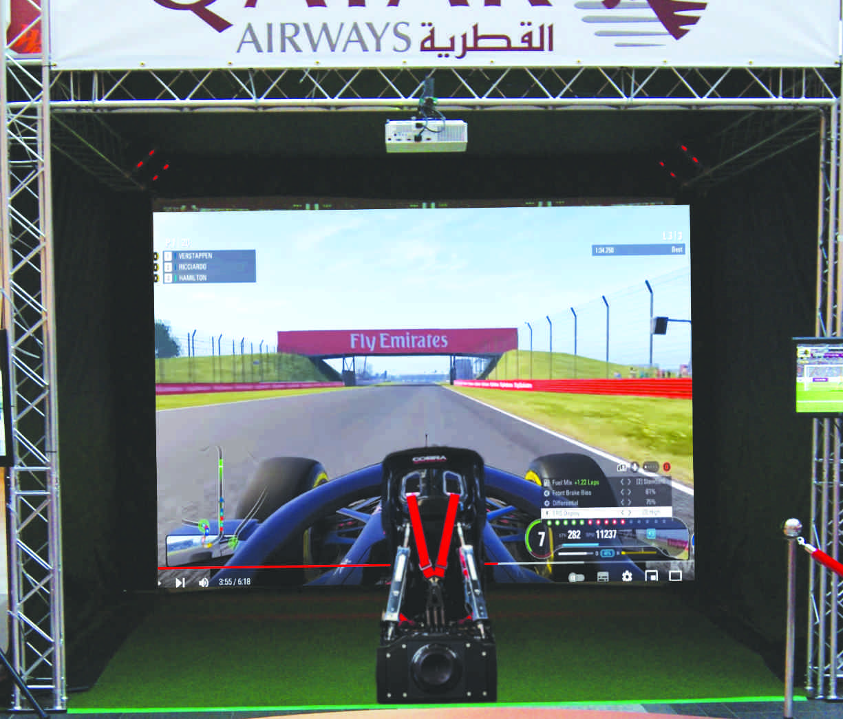Motion simulator car racng on giant screen
