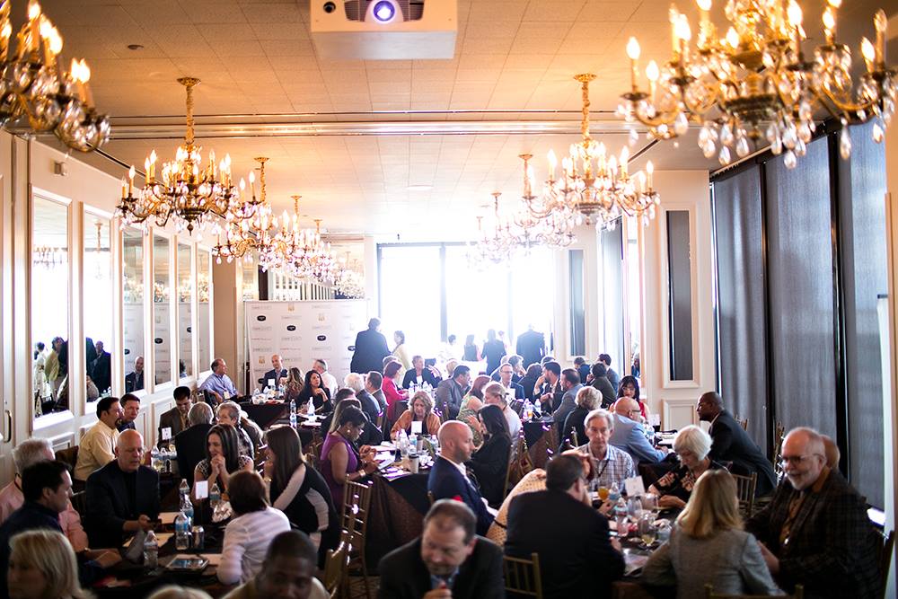 Guests networking at a C-SUITE NETWORK executive reception