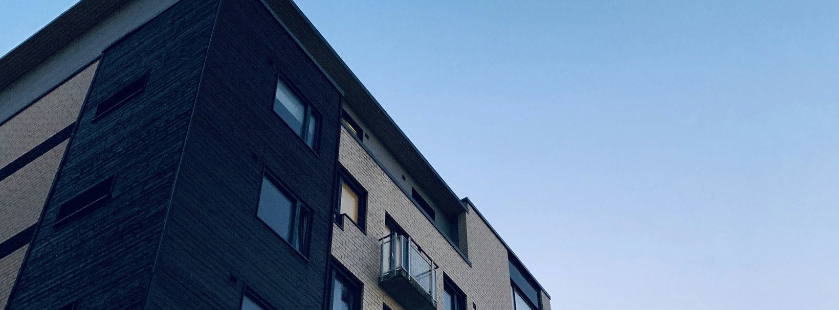 Contemporary residential tower with many balconies across its facade