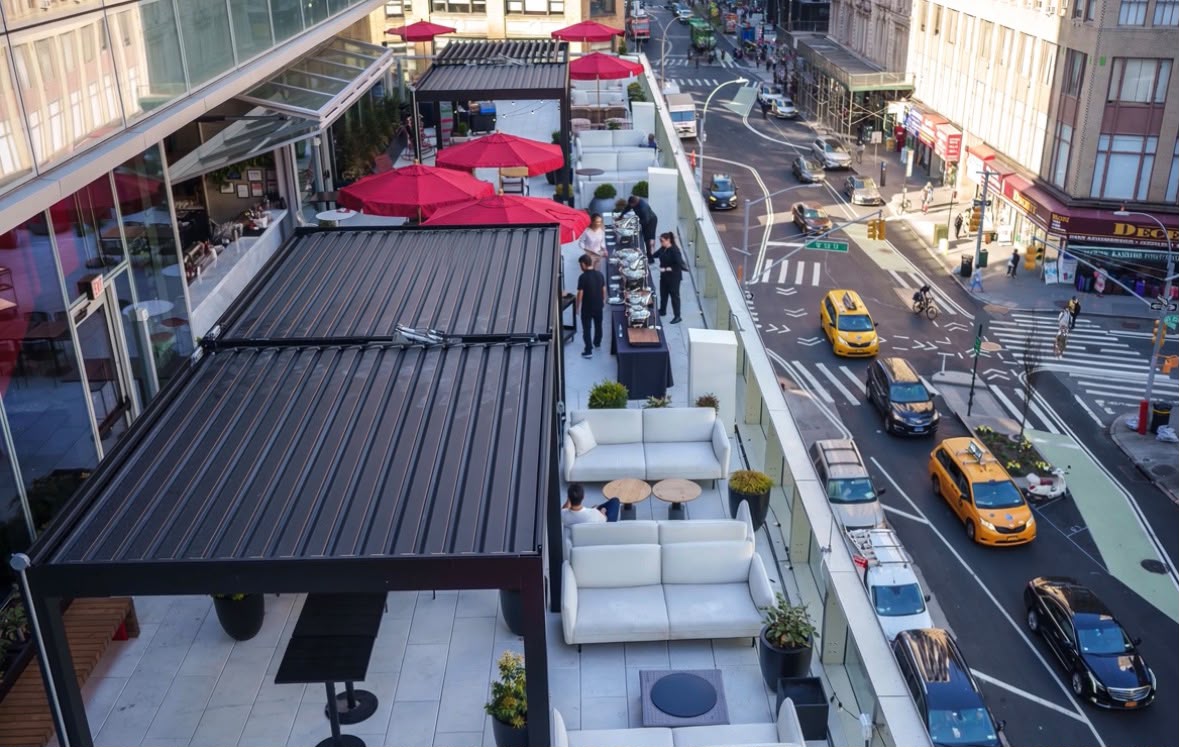 Large commercial rooftop with pergola systems overlooking a city street