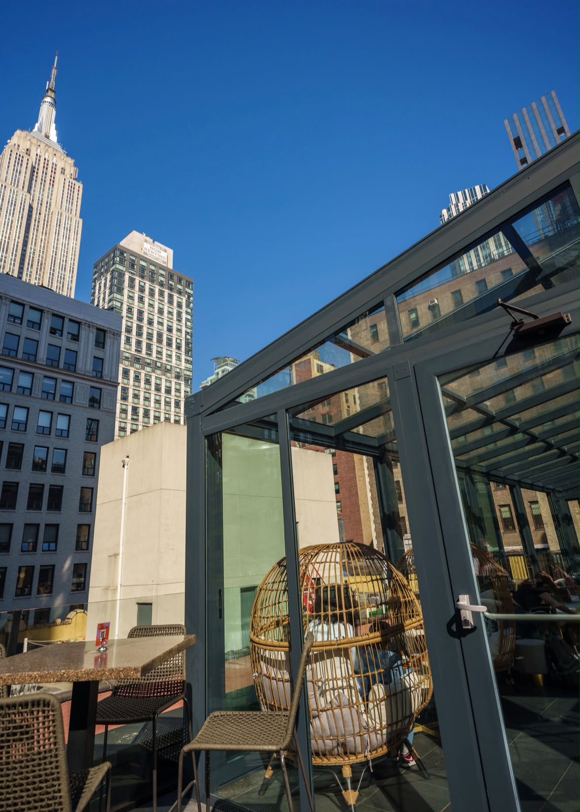 Glass rooftop enclosure with Empire State Building view