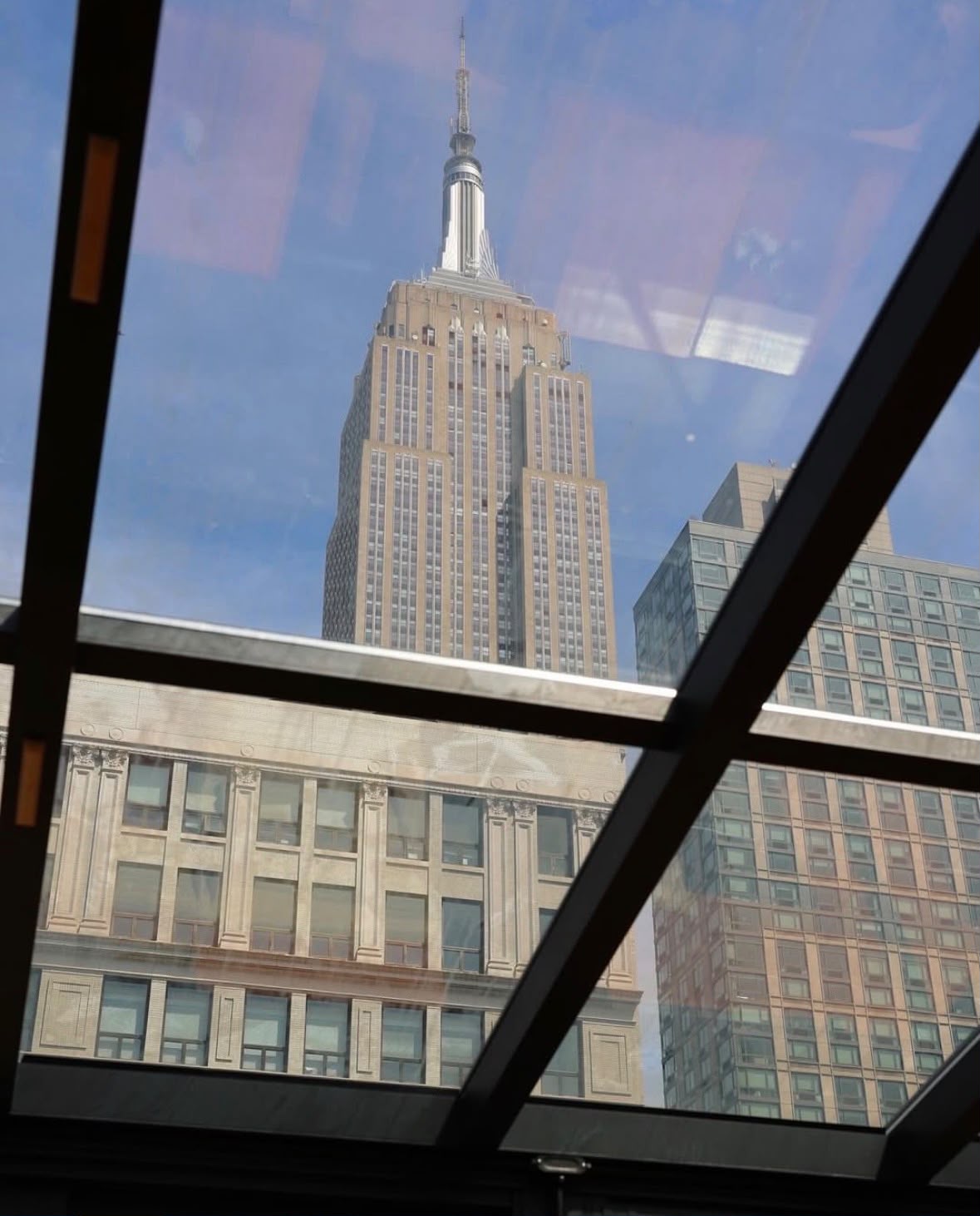 City skyline viewed through a rooftop glass roof system