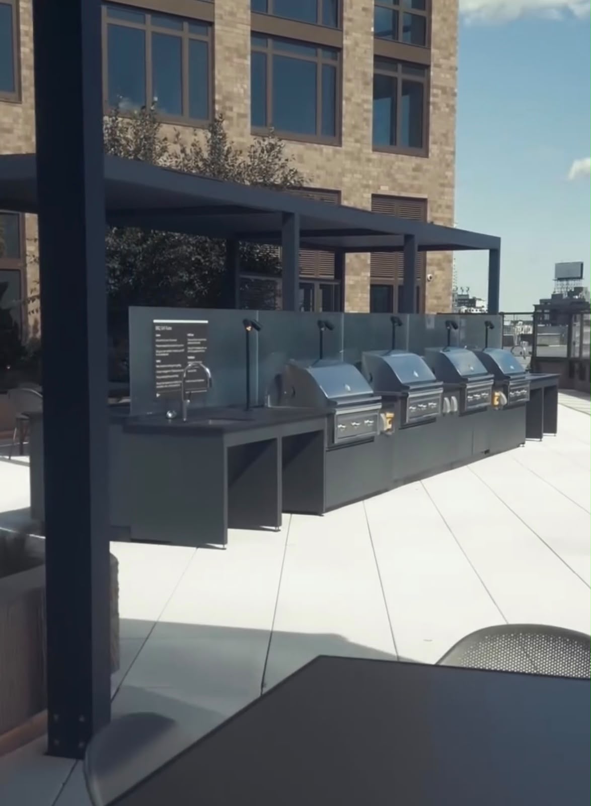 Rooftop amenity and grilling area under a commercial structure