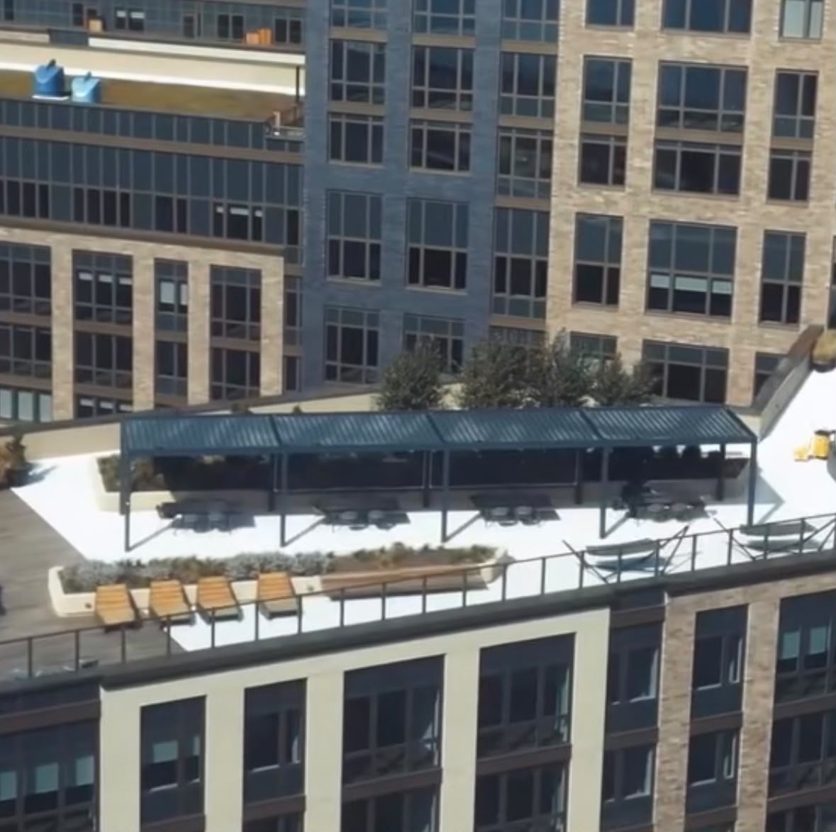 Elevated view of a long commercial rooftop pergola installation