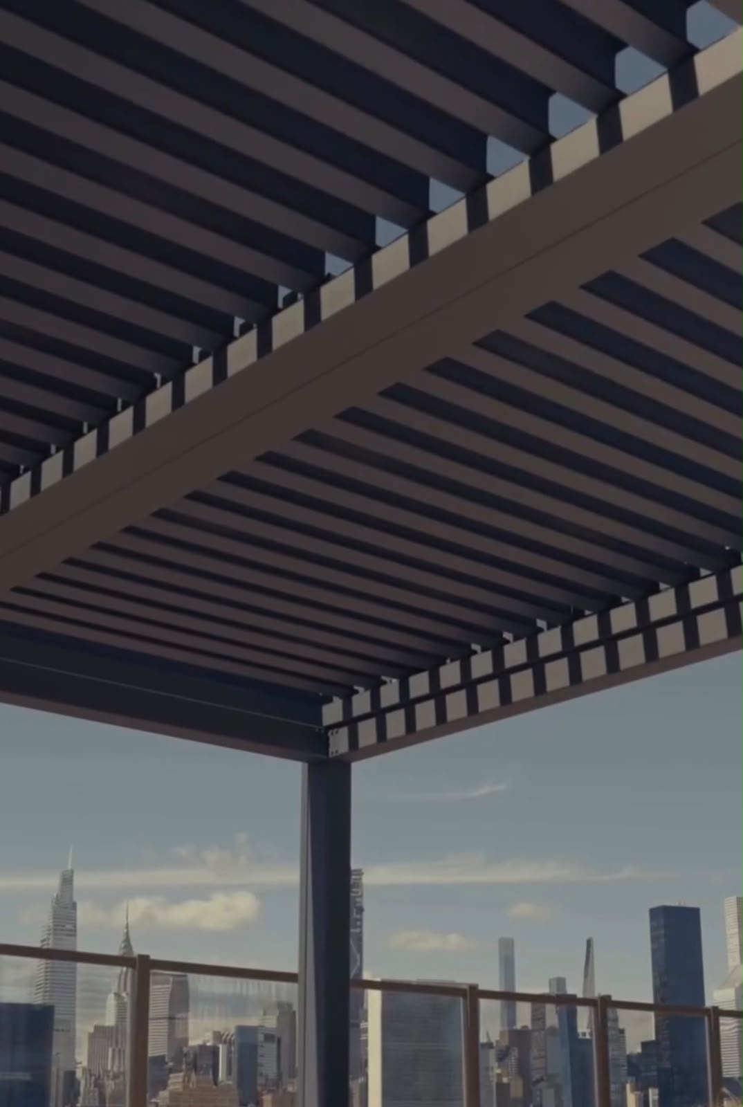 Close view beneath a commercial louver pergola with city skyline