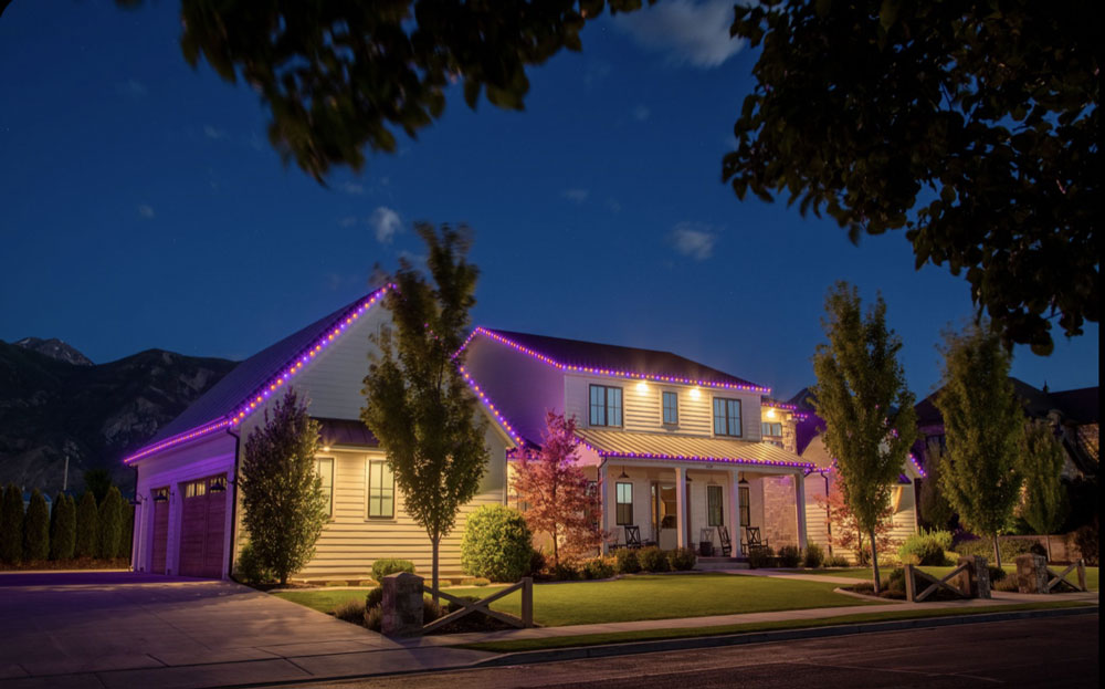 A home with warm white holiday lighting along the roofline, illustrating holiday lighting in Plymouth, Michigan.