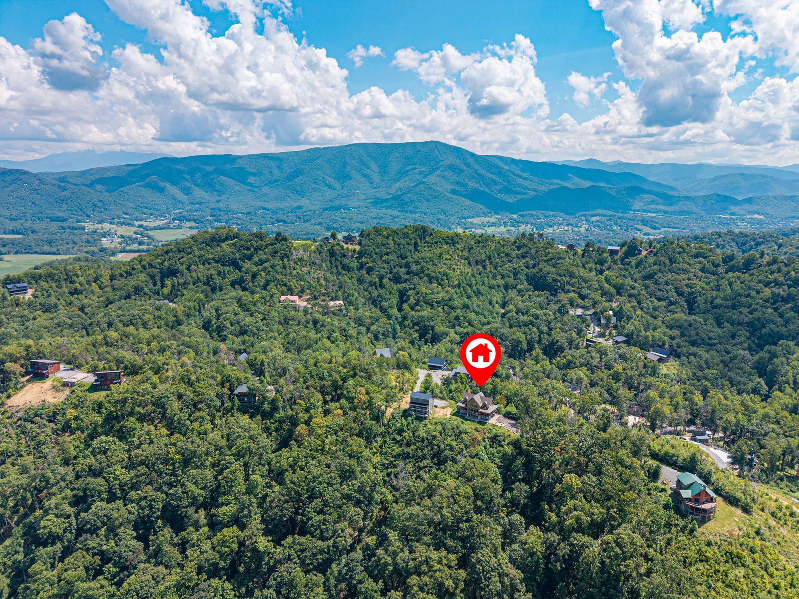 Aerial view of the cabin's ridge and the mountains behind it