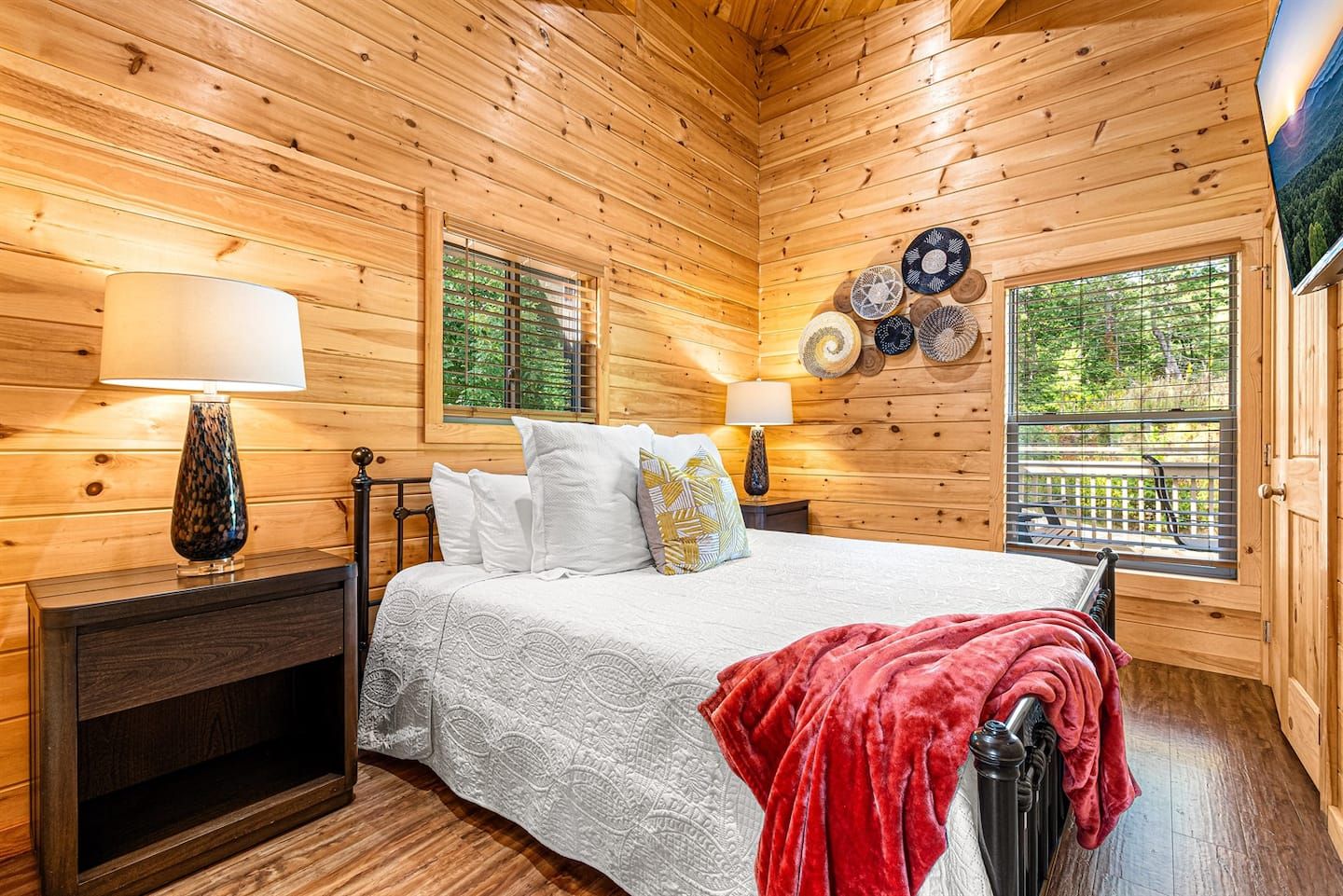Upstairs, the second bedroom boasts a luxurious king-sized bed, soft linens, and a 49" Smart TV for your entertainment. A spacious closet offers ample storage for travel essentials. The room is a quiet, cozy retreat perfect for restful nights.