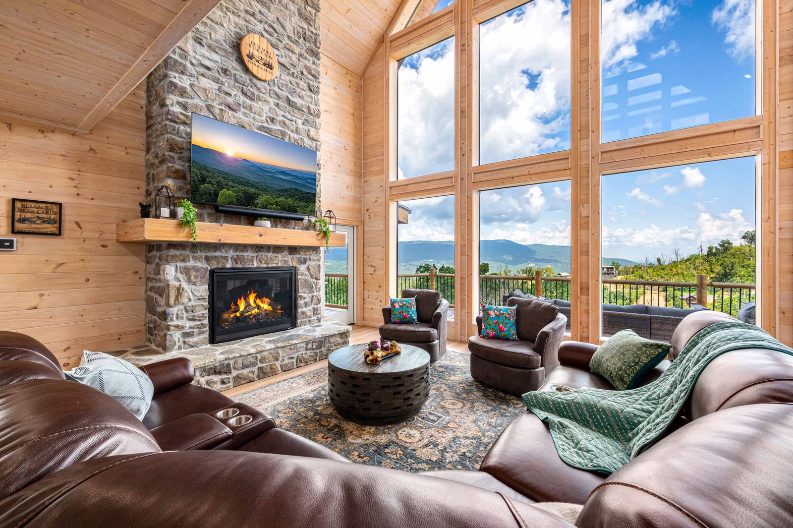 The great room's stacked-stone fireplace and wall of windows