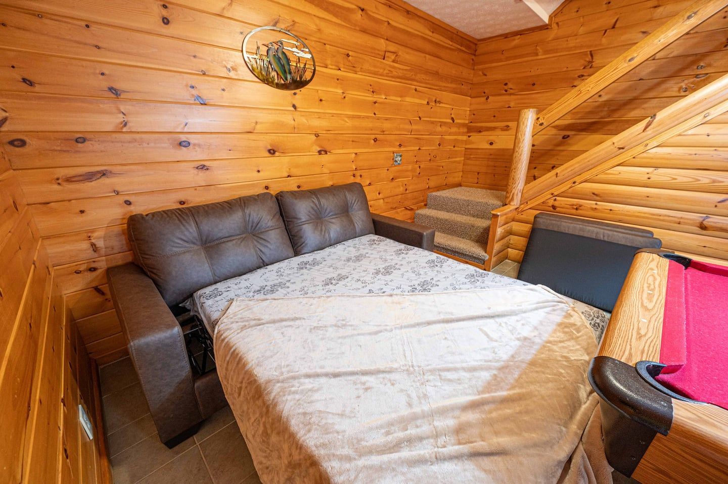 The sofa bed downstairs pulls out with a queen mattress.