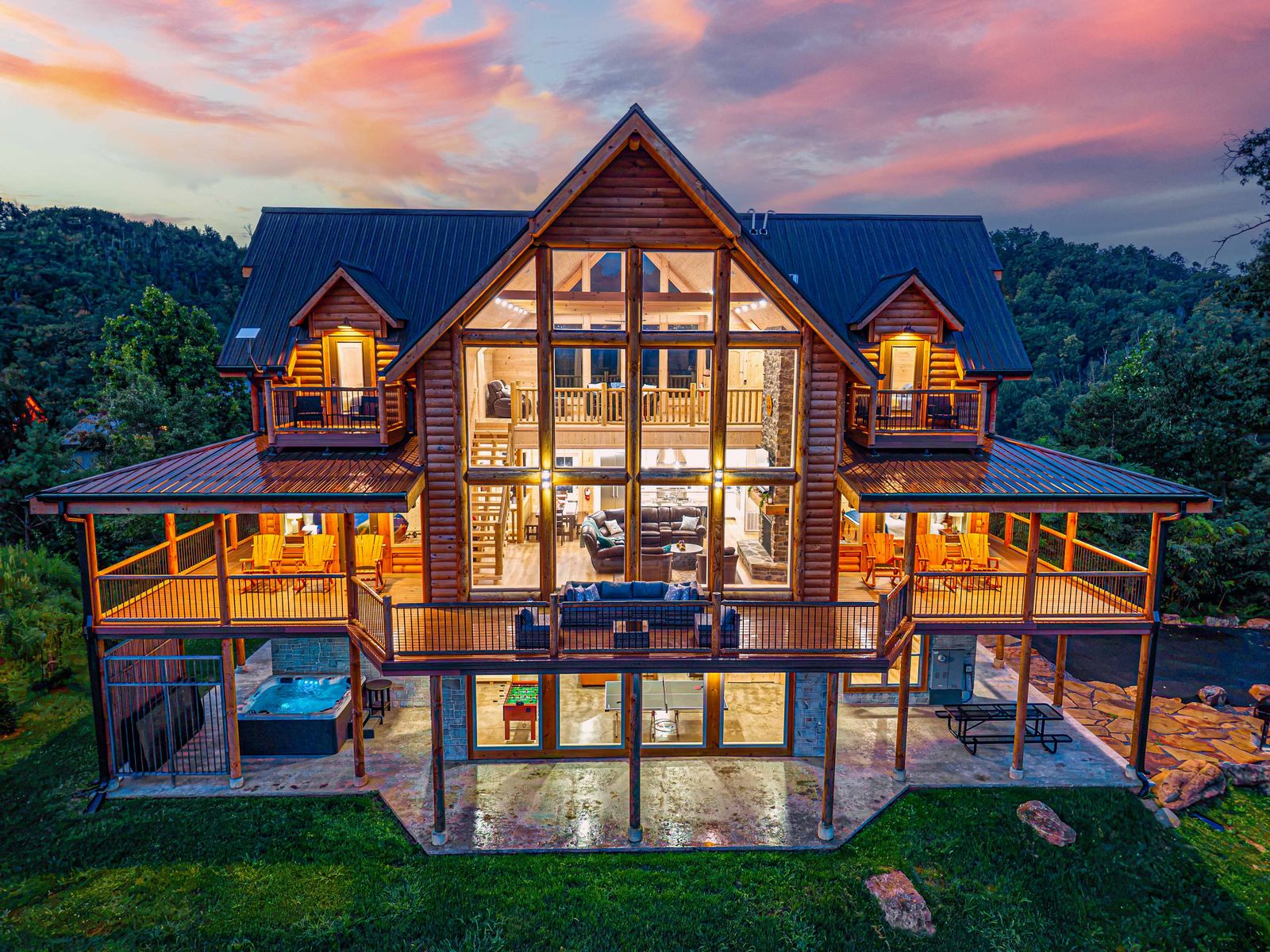The glass front of the cabin lit up at dusk