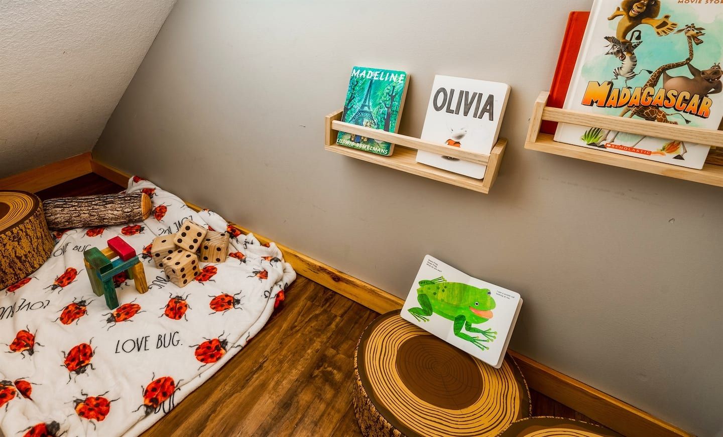 Nestled under the stairs, our delightful children’s nook provides a special corner for young adventurers to explore. This charming space is tailored for play and creativity, inviting little ones into a world of imagination, fun, and wonder.