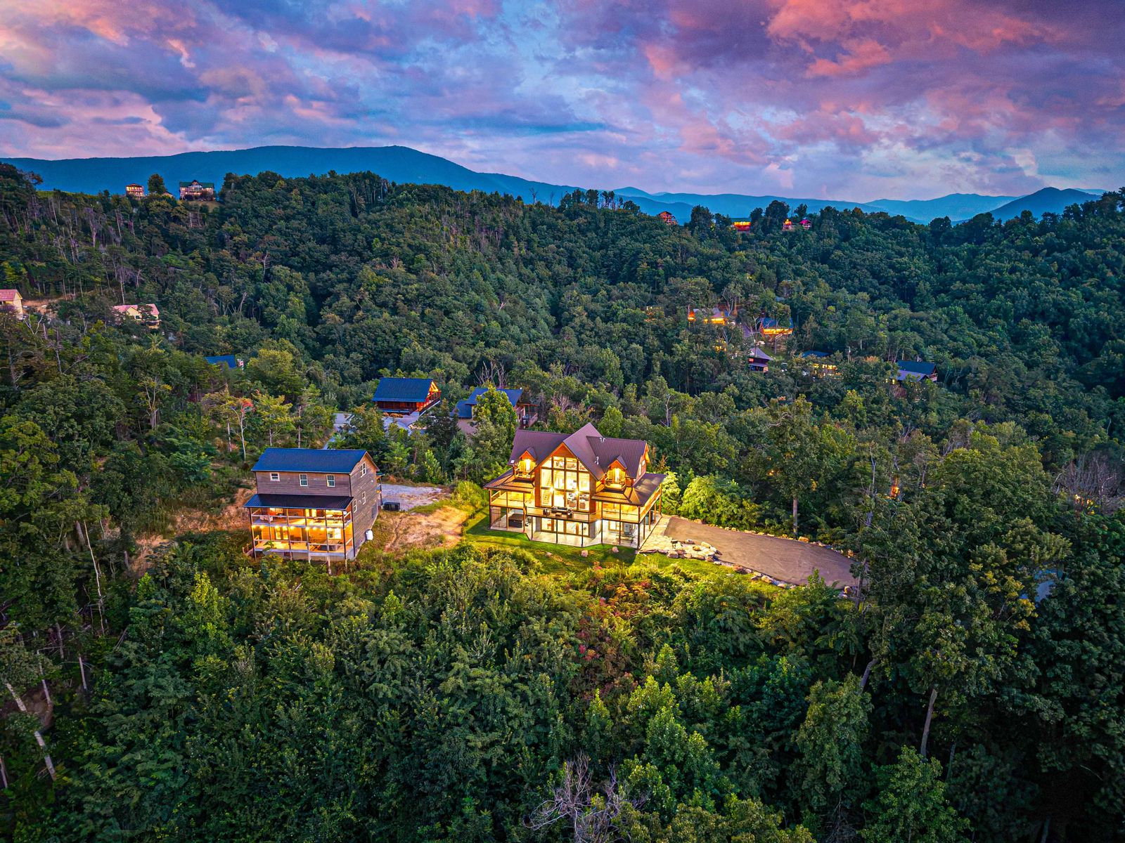 The cabin on its wooded ridge at twilight