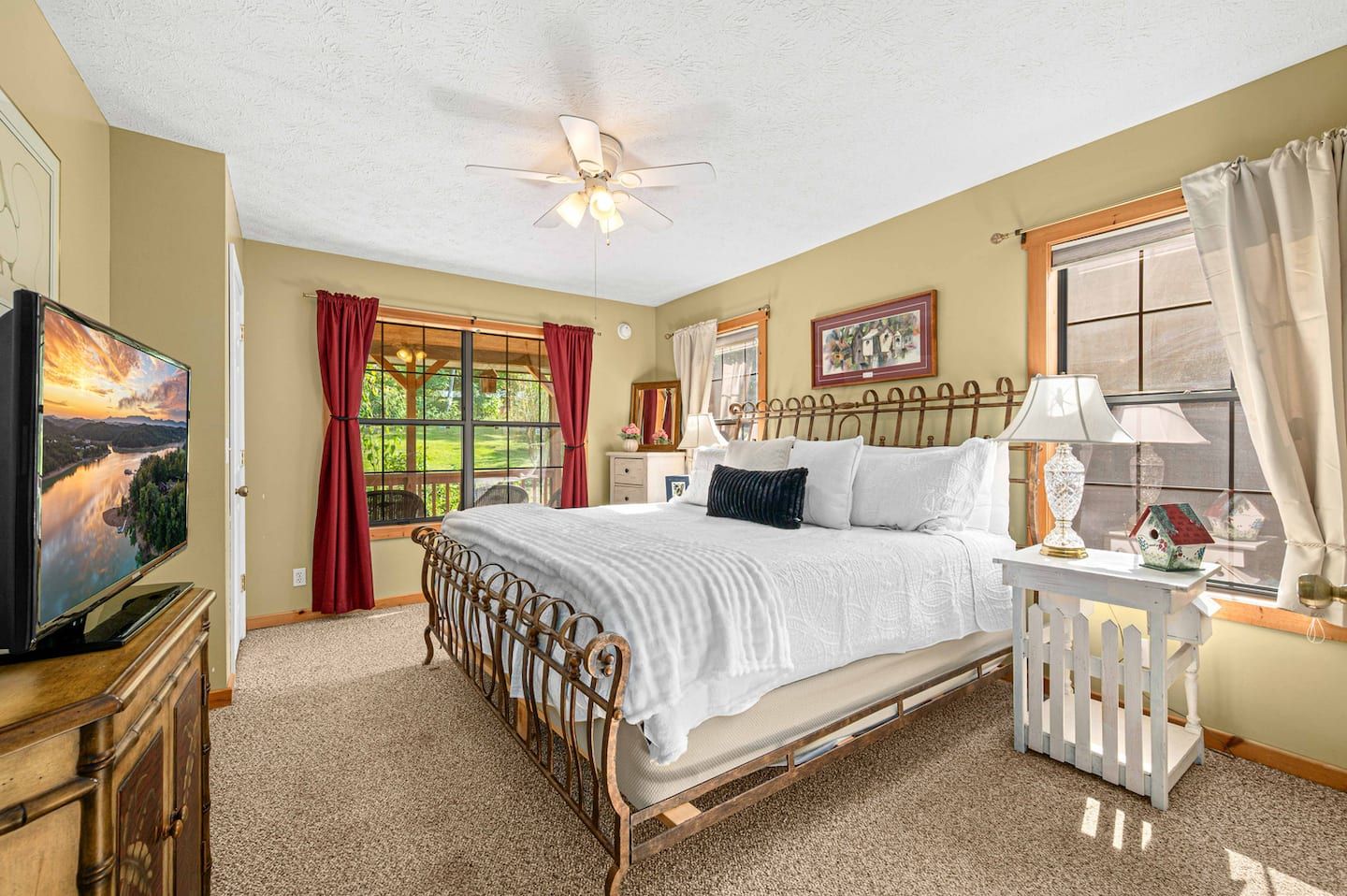 The main-level master bedroom, with a king bed and a TV for the nights nobody wants to move.