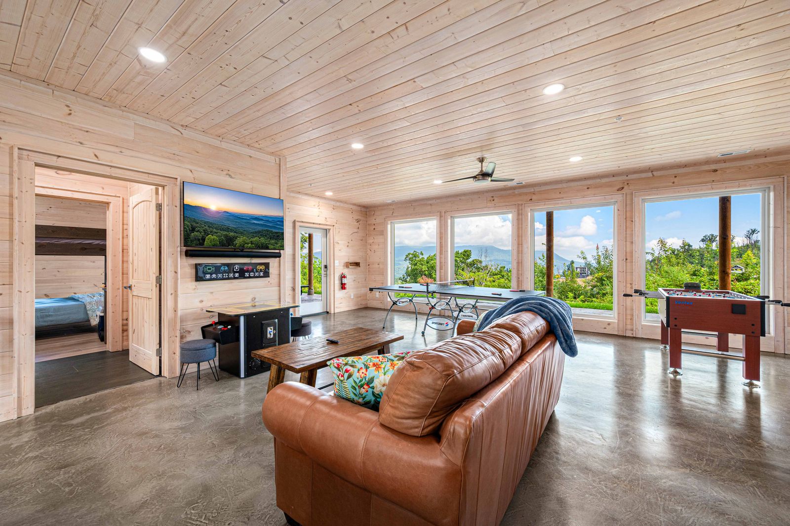 Game room lounge with mountain windows