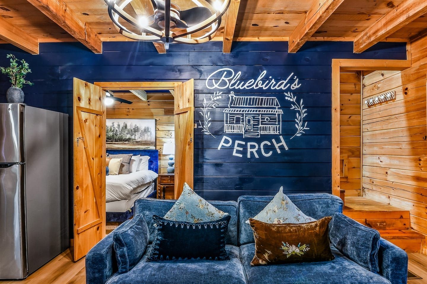Soft textures and comfortable seating pair with the cabin’s signature blue accents, creating a warm and inviting space to snuggle up and reminisce over the day's activities.