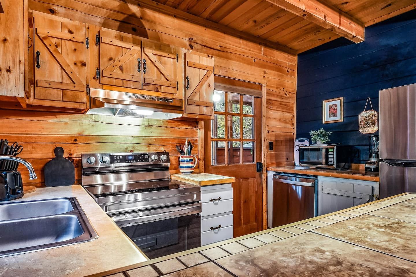 Centered at the heart of the cabin, the kitchen brings people together — a warm, functional space where cooking feels easy and every meal becomes part of the memory.