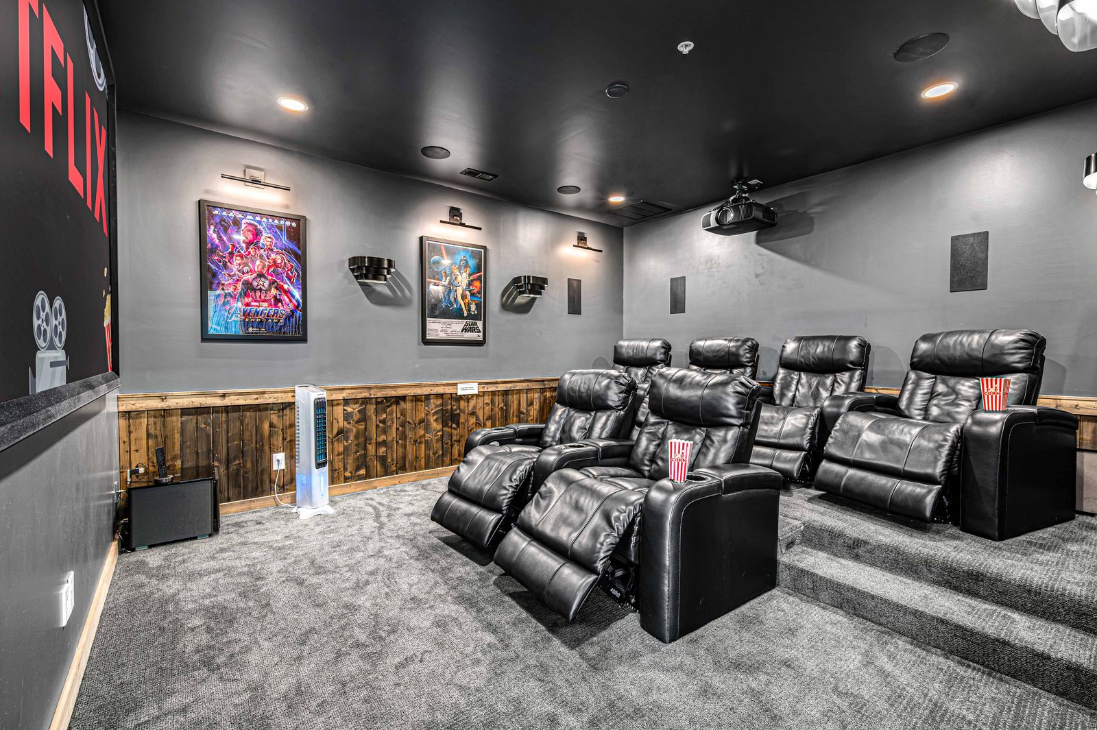 The home theater with rows of leather recliners