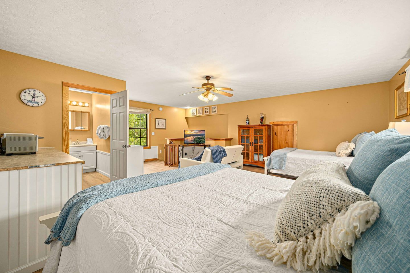 Two queen beds in the above-garage apartment, including a kitchenette of its own.