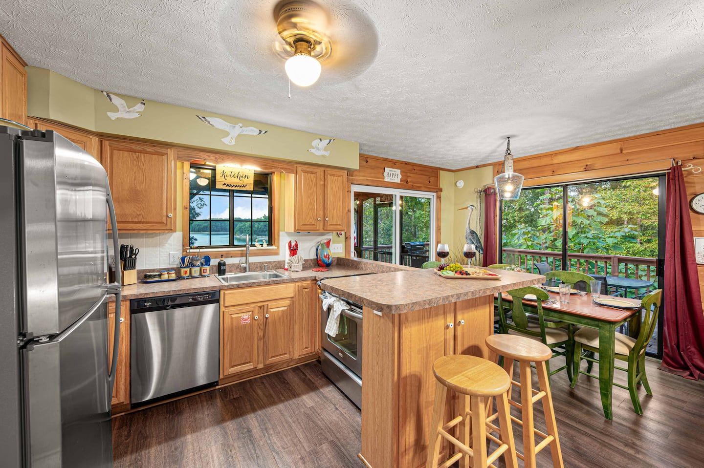 The fully equipped kitchen has a Douglas Lake view, an island with bar seating, and full-size stainless appliances.