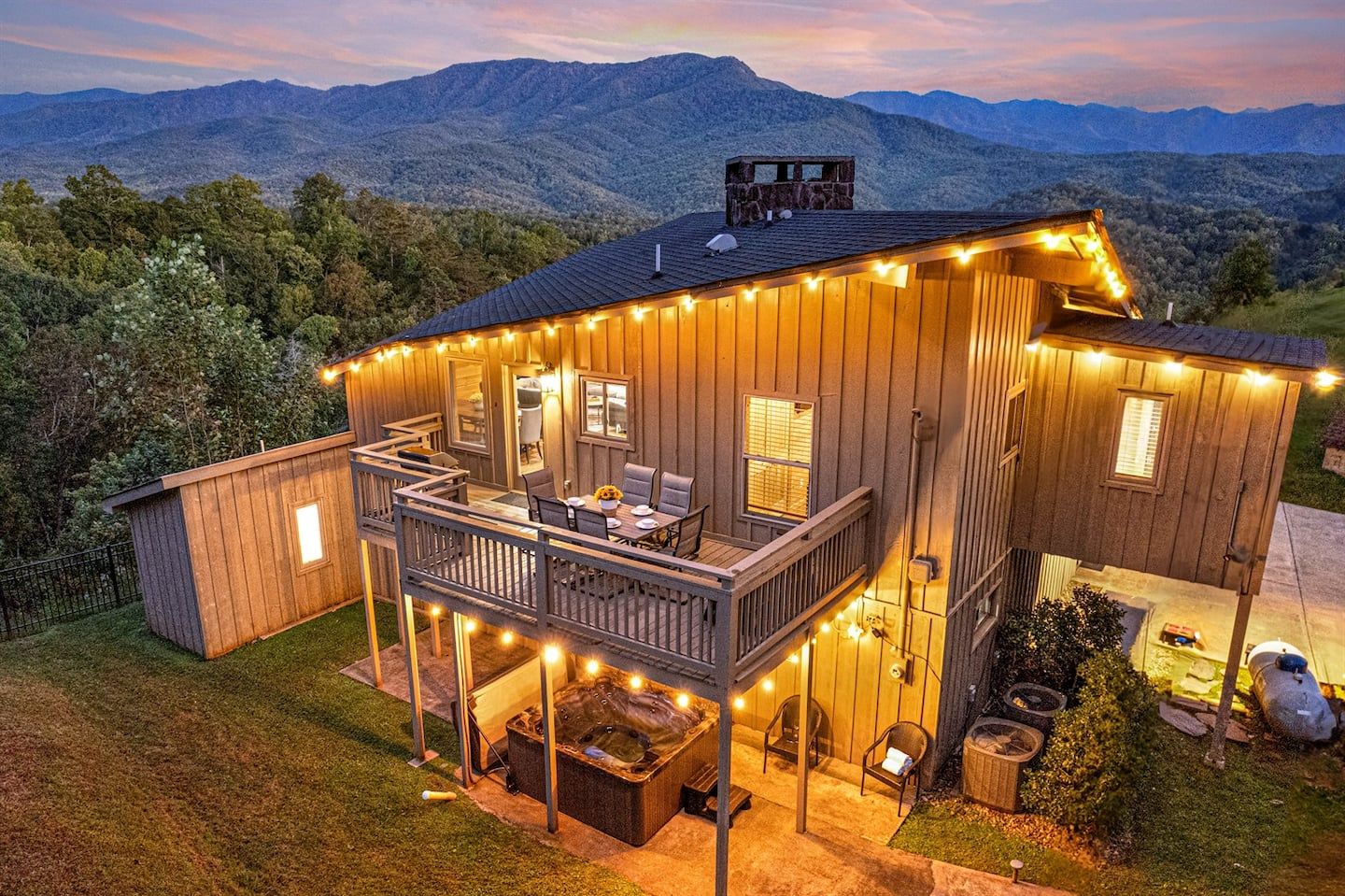 From above, Birdsong Ridge reveals itself — a stunning mountaintop retreat nestled into the forest, with decks, porches, and balconies all oriented toward the mountain, with the wild beauty of the Smokies surrounding it on every side.