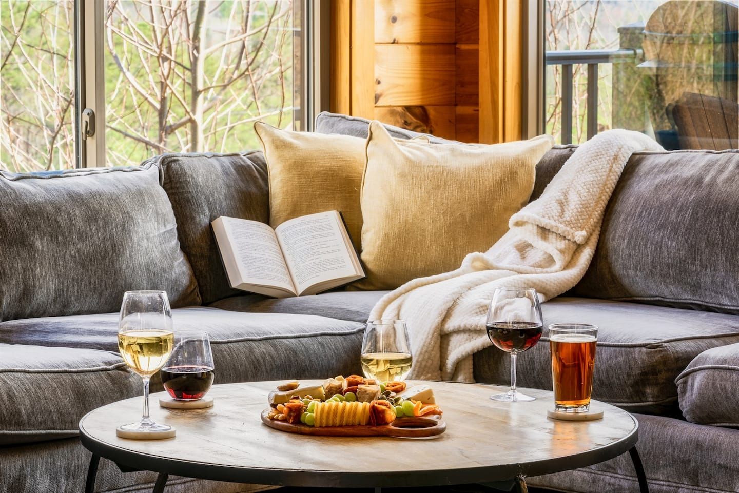 Cozy up in the living room on a brisk winter day, where warmth and comfort meet sweeping mountain views beyond the windows. Settle into the sofa with a book, a glass of wine, and a bite to enjoy while the Smokies create a beautiful winter backdrop.