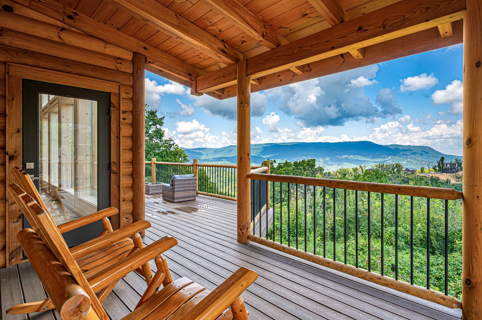 Rocking chairs on the covered deck facing the mountains