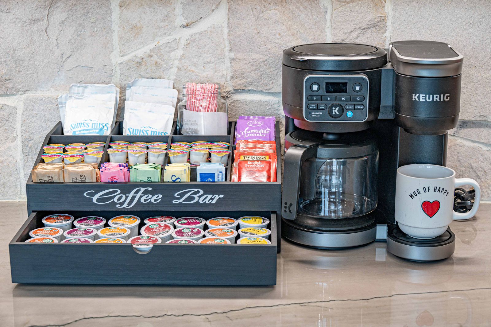 Coffee bar stocked with pods, tea, and fixings