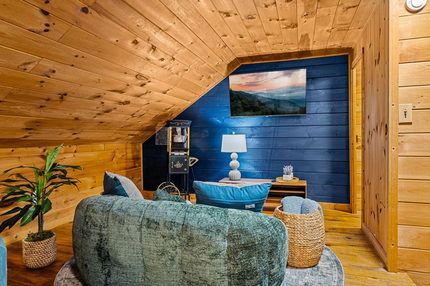 The loft lounge with a round sofa, TV, and popcorn machine