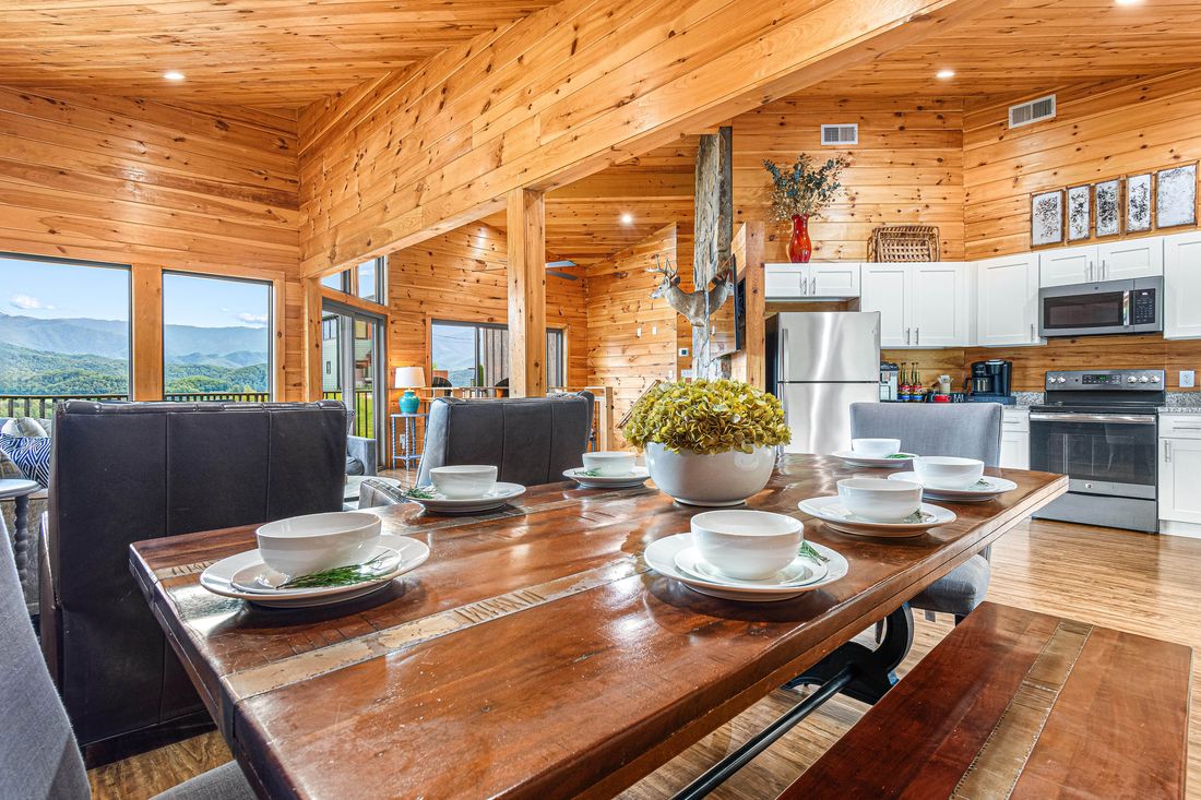 The dining table set for dinner with the view behind it