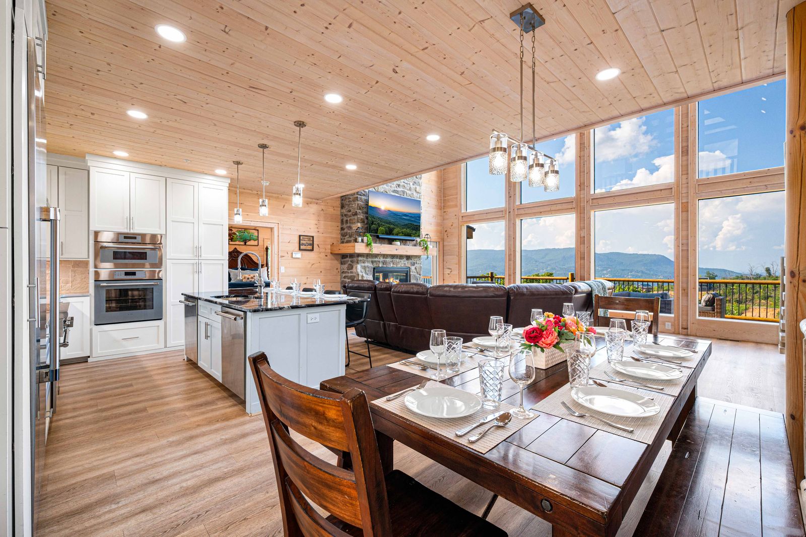 Dining table set for a group, kitchen beyond