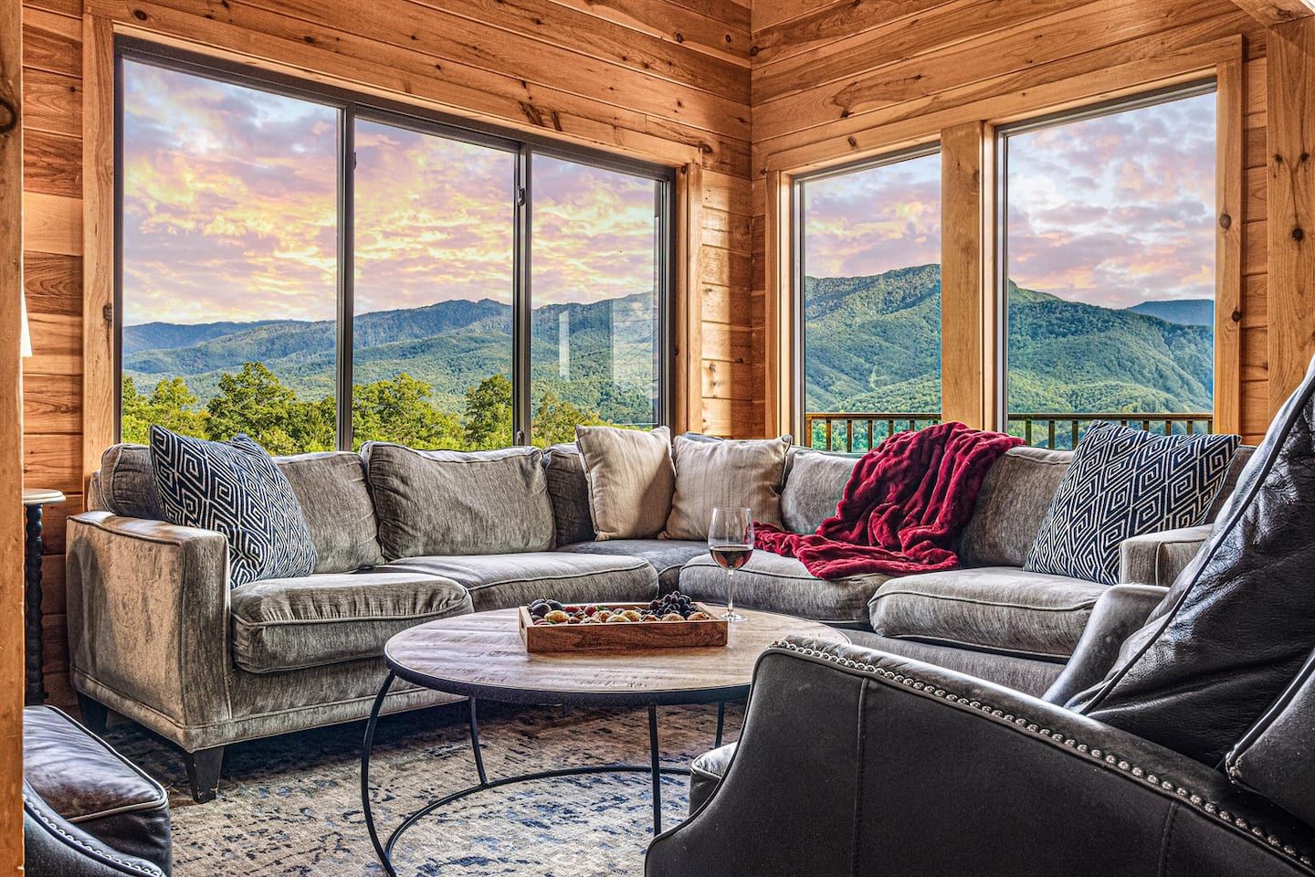 This is the view that stops guests in their tracks. The living room's wall of windows frames an unobstructed, sweeping panorama of the Great Smoky Mountains — wider and more breathtaking than nearly any comparable property in the region.