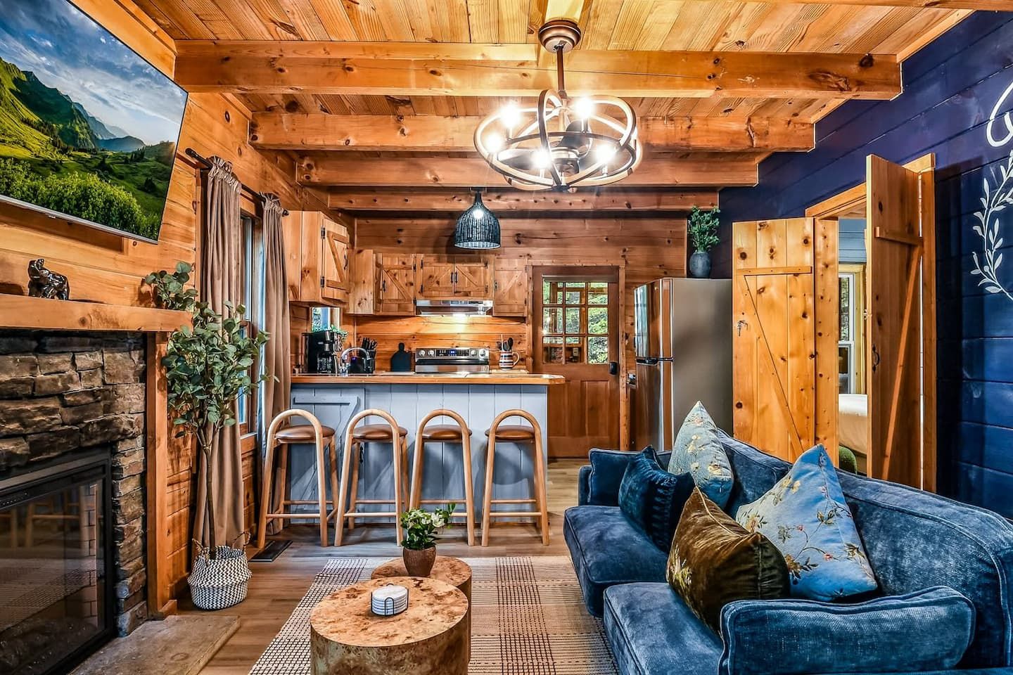 The heart of the cabin brings everyone together — an open living and kitchen area designed for comfort and connection. Whether you’re cooking a meal, sharing coffee, or relaxing by the fire, this space feels easy, inviting, and unmistakably home.