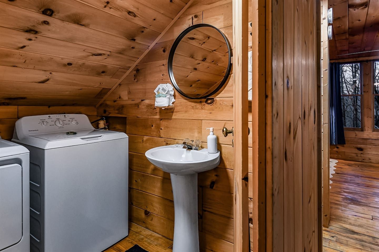 Tucked into the loft, the half bath adds everyday convenience with a washer and dryer close at hand — making longer stays, fresh clothes, and easy resets part of the experience without ever leaving this private upper level.
